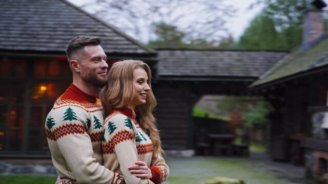 Young handsome man hugges girl outside. Beautiful couple outside at autumn nature background.