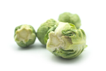 Closeup of organic brussels sprouts on white background