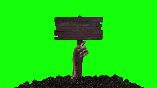 A zombie hand with a wooden sign crawls out of the ground on a green screen