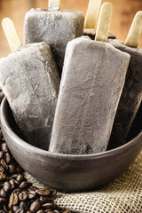 sweet coffee ice cream, in handmade clay bowl, with coffee beans around. Cappucino Popsicles