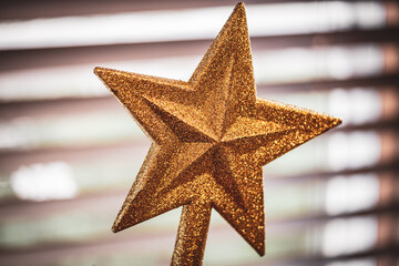 A golden glitter star for the top of a Christmas tree