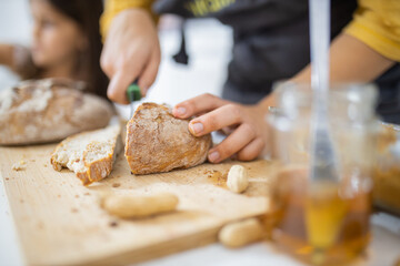 Female hands slicing bread on a cutting board
