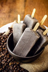 sweet coffee ice cream, in handmade clay bowl, with coffee beans around. Cappucino Popsicles