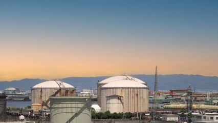 Fototapeta premium Oil refinery petrochemical plant factory from Osaka chemical industry zone of Japan. oil and gas petrochemical industrial. many oil storage tank and pipeline steel. Ecosystem environment concept