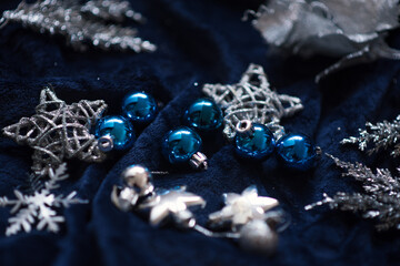 Christmas decoration on royal blue background. Top view on stars, wings and ornaments. 