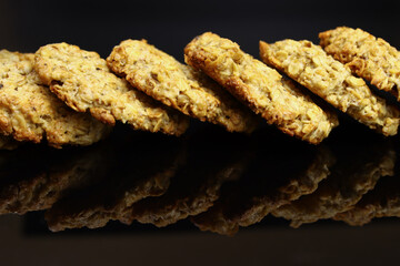 sweet homemade oatmeal cookies on a mirrored black table