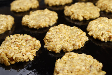 Raw homemade oatmeal cookies on a baking sheet