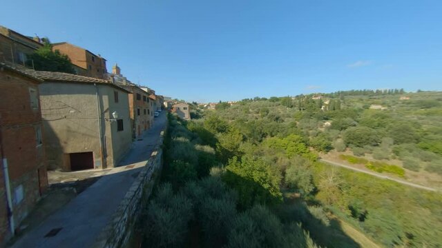 Drone Ascending Towards Tiled Roof Houses In Sinalunga Tuscany, Italy - Aerial