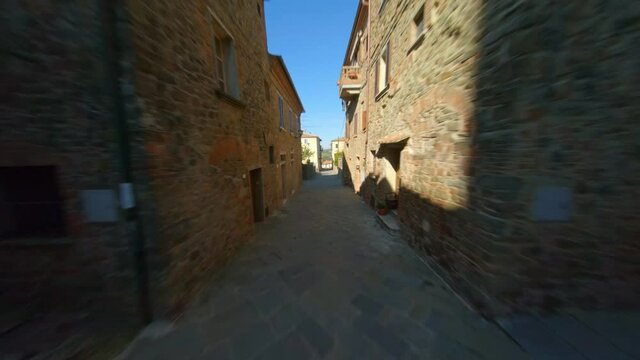 Drone Flying Through Alleyway In Community Of Sinalunga, Tuscany Italy - Aerial