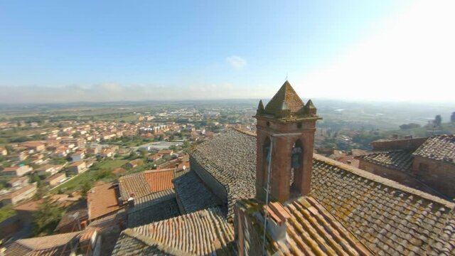 Aerial View Of The Comune Of Sinalunga In Siena, Italy With Ancient Churches On A Sunny Day - drone shot, fpv