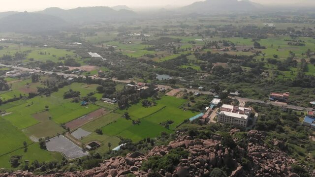 Green fields covering the landscape on both sides of a highway in India