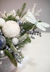 Christmas bouquet in round box. White and blue decor, Christmas tree decorations with fir branches. Gift box for Christmas.