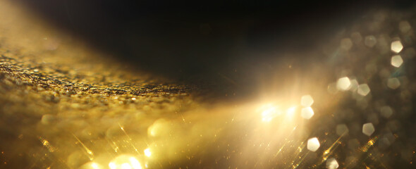 background of abstract gold and black glitter lights. defocused