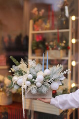 Christmas bouquet in basket. Christmas tree branches with new year decoration. New year bouquet flowers and fir branches in a basket