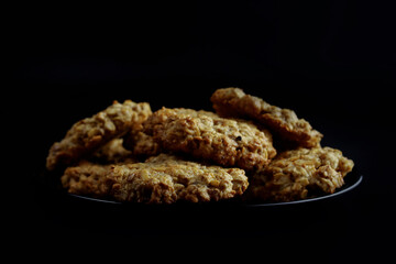 sweet homemade oatmeal cookies on a black plate