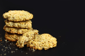 sweet homemade oatmeal cookies on a black background