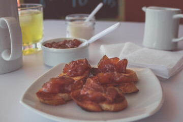 Homemade bread toast with a delicious homemade apple and onion chutney, with cinnamon on a light white board. Perfect jam for breakfast. Breakfast, cooking, food concept.