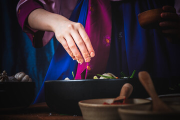 Close up images of Hand of Korean woman, she making Kimchi which is a fermented food preservation of Korean people consisting of many fresh vegetables and fruits