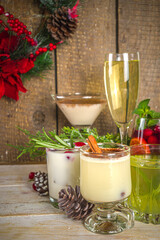 Set of different Christmas and winter drinks. An assortment of Christmas cocktails, hot and cold beverages, in cozy wooden home background with Xmas decor