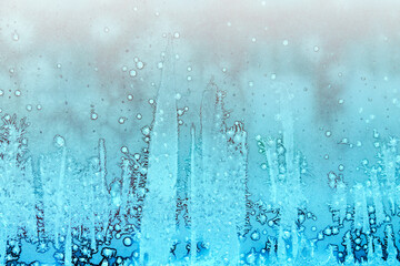 Frosty patterns on glass. Beautiful winter background. Christmas and New Year.