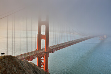 People Standing on Cliff near the Golden Gate Bridge on Foggy Morning. Sausalito, Marin County, California, USA.