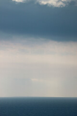 sun rays shine through the stormy clouds over Black sea in Crimea