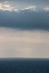 sun rays shine through the stormy clouds over Black sea in Crimea