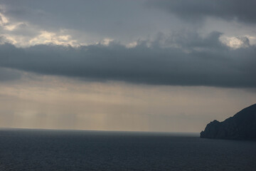 sun rays shine through the stormy clouds over Black sea in Crimea