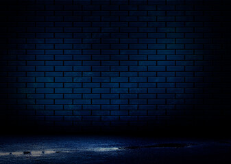 Dark brick wall, blue neon light. Rays and glare of light in the dark. Night view of a dark street, abstract projection on an empty wall.
