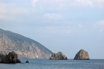 view of the Black sea and mountain Ayu-Dag (sleeping bear) in Crimea under cloudy sky