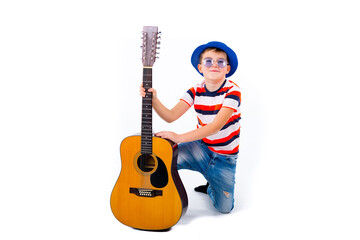 A boy kid holding guitar on a white studio background