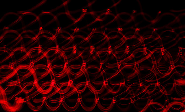 Light Trail From Red Gaming Keyboard In A Dark Room