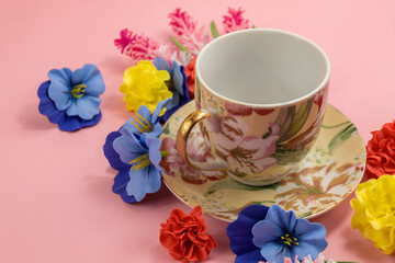 Cozy design, tea set on a pink background with decorative flowers, flat lay