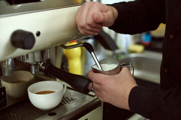 Fototapeta na wymiar The process of whipping milk in a coffee machine