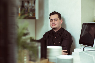 Portrait of a barista behind the bar