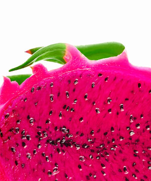 Close-up macro shot of pitaya, pitahaya dragon fluit sliced in half. Exotic superfood vibrant cactus fruit. Magenta pink colored flesh with black seeds. Space for text on white background