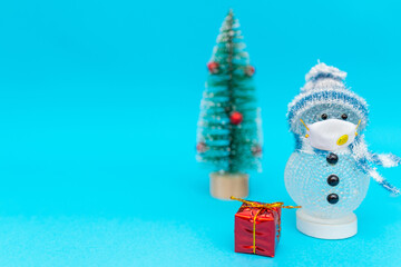 snowman with face mask presents and Christmas tree with copy space.new year celebration.