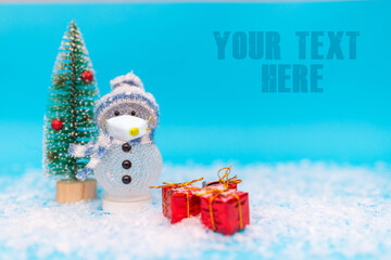 snowman face mask on a blue background with presents.Front view.