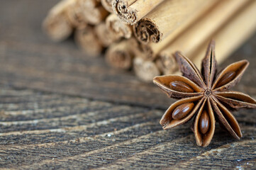cinnamon sticks and anise on a wooden background
