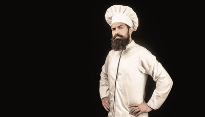 Serious cook in white uniform, chef hat. Portrait of a serious chef cook