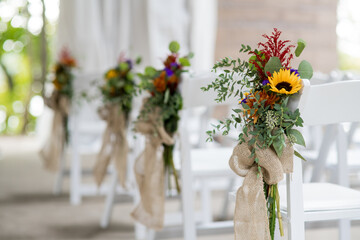 wildflower and burlap bouquets on ceremony chairs