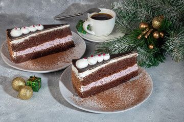 Festive cake with chocolate and crispy interlayer. Two portions. On a gray background. Birthday, holidays, sweets.
