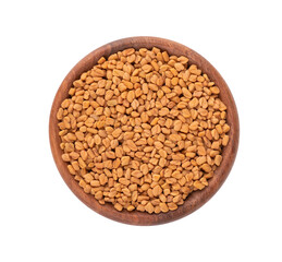 Fenugreek seeds in wooden bowl, isolated on white background. Shambala, helba seeds. Top view.