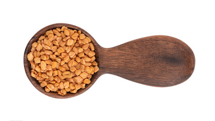 Fenugreek seeds in wooden spoon, isolated on white background. Shambala, helba seeds. Top view.