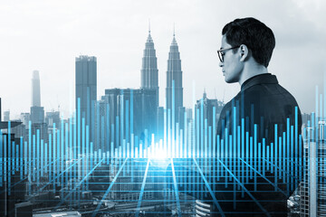 Handsome eastern trader checking quotes to forecast the capital market behavior. Concept of trading strategy. Forex chart. Kuala Lumpur. Double exposure.