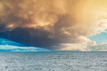 Stormy sky over the calm surface of the sea.