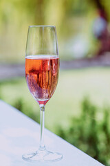 glass of rose sparkling wine outdoor. Celebrating, relax, travel concept