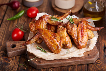 Backed Chicken wings served with rosemary. Delicious homemade appetizer.