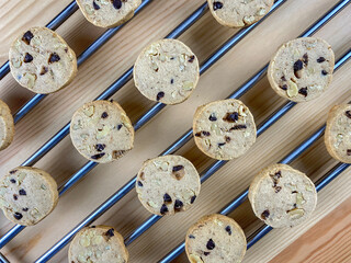Warm, golden brown, chocolate chip cookies cooling on a rack.