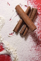 Three cinnamon sticks lie on a white-colored background cooking a penny a copy of the space